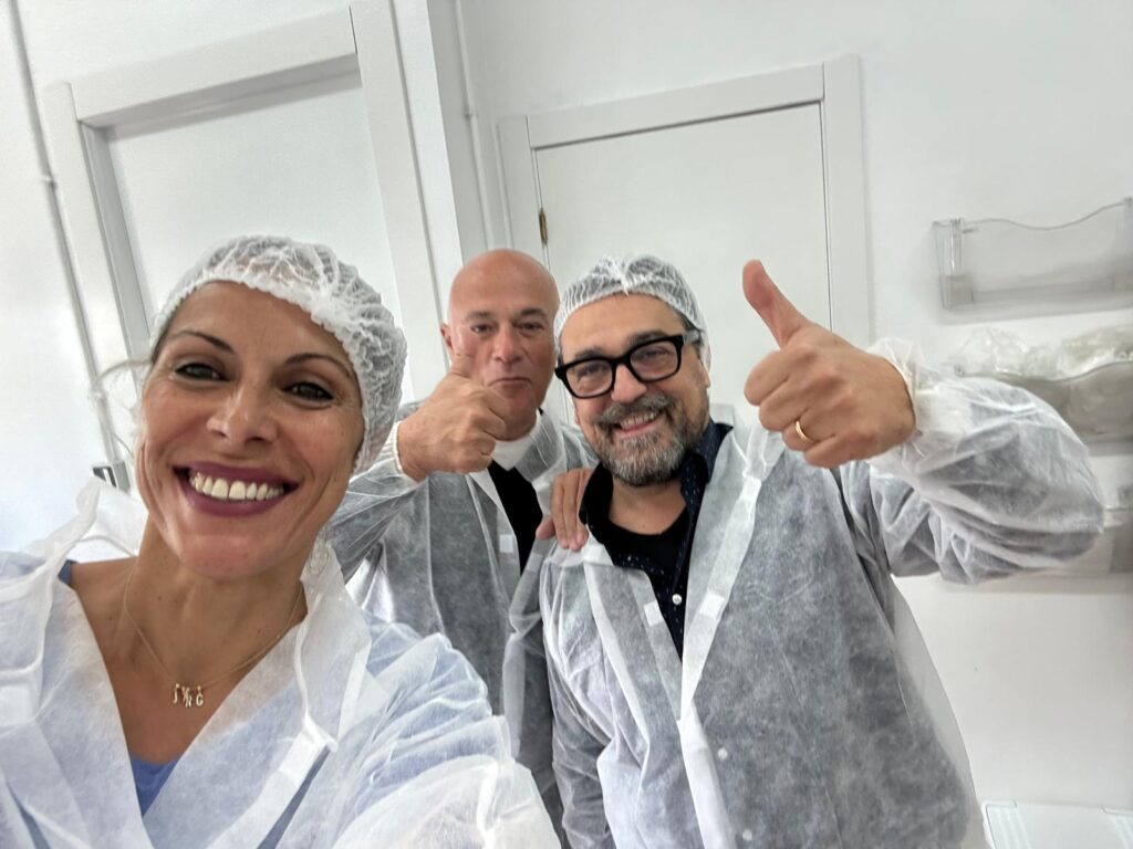 Khansaa Ruiz inside a coffee production facility with factory team